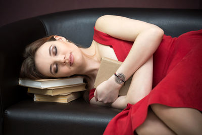 Portrait of young woman lying on sofa