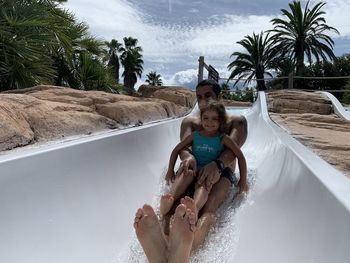 Rear view of woman sitting on beach
