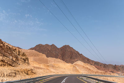 A road next to a mountainous desert landscape. road 12 on the way to eilat, israel, on the egyptian