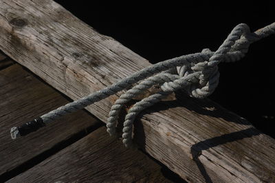 High angle view of rope tied up on wood