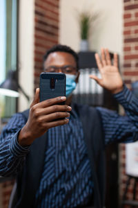 Man using smart phone at home