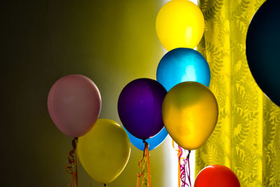 Close-up of colorful helium balloons at home