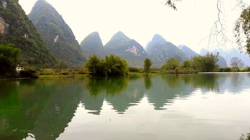 Scenic view of lake and mountains against clear sky