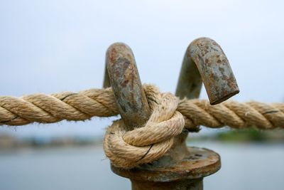 Close-up of rope tied up on rusty metal