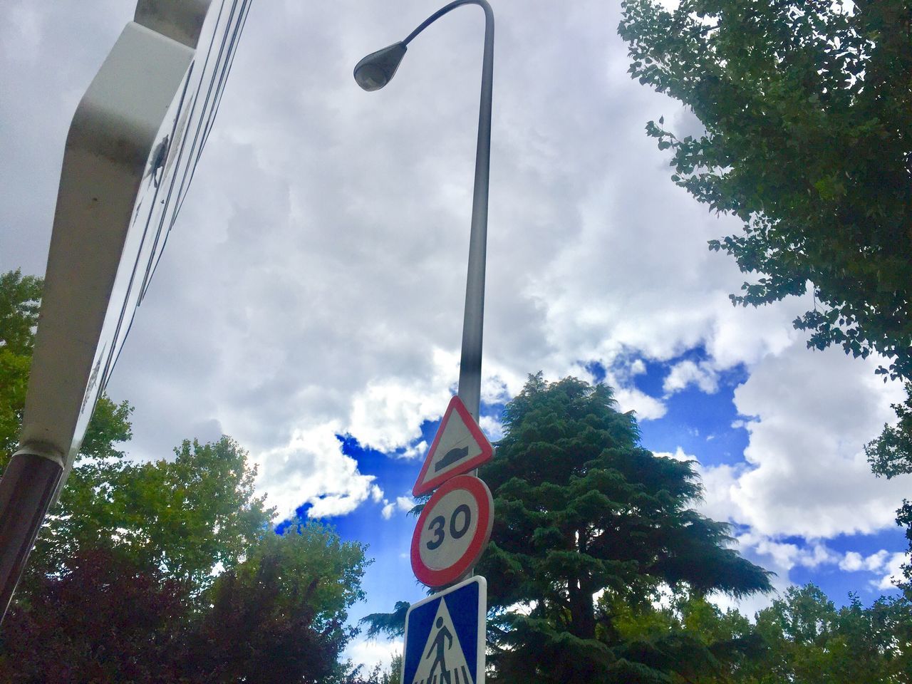 LOW ANGLE VIEW OF ROAD SIGNS AGAINST SKY