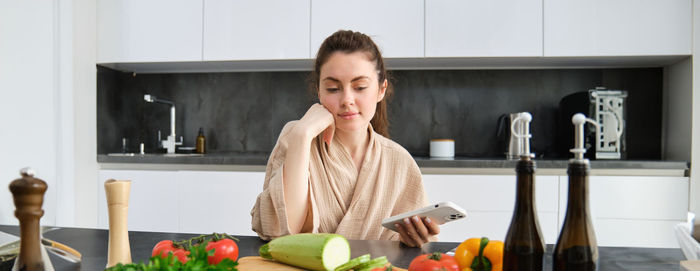 Portrait of young woman sitting at home