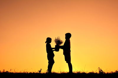 Silhouette of children at sunset