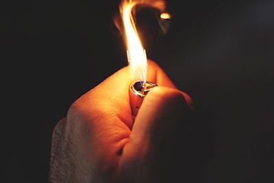 Close-up of hand holding burning