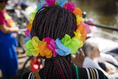 Rear view of woman with multi colored flowers