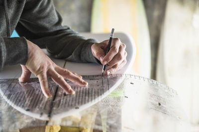 Surfboard shaper refining a new design