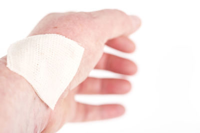 Close-up of hands over white background