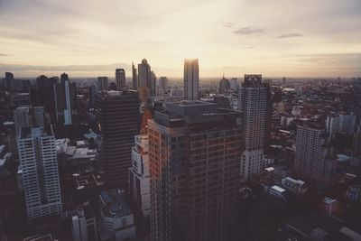 Cityscape against cloudy sky