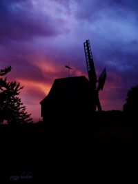 Low angle view of silhouette trees against sky at dusk