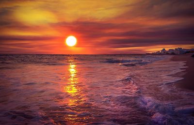 Scenic view of sea against romantic sky at sunset