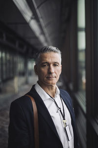 Portrait of entrepreneur standing in office corridor