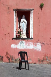 Chair on table against wall in building