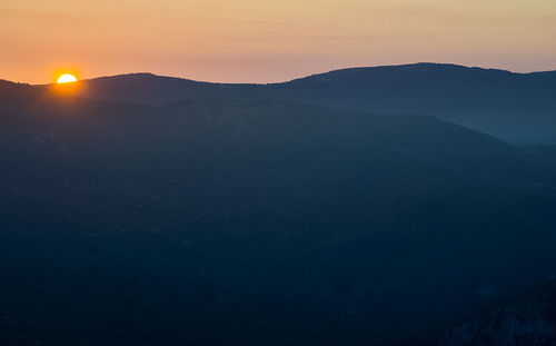 Scenic view of silhouette mountains against sky during sunset