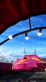Low angle view of illuminated tent against sky