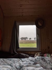 Scenic view of field seen through window