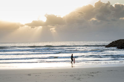 People on beach against sky