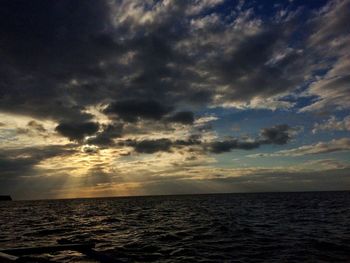 Scenic view of seascape against sky at sunset