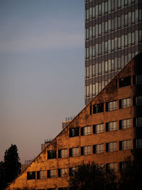 Low angle view of buildings against sky at sunset