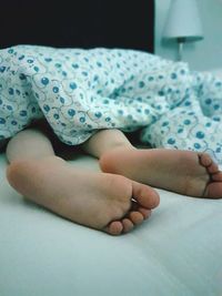 Close-up of baby sleeping on bed