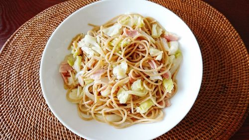 High angle view of noodles in plate on place mat