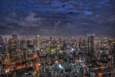 High angle view of city lit up at night