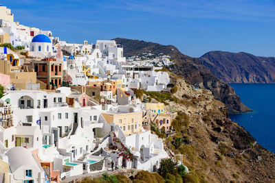 High angle view of townscape by sea against sky