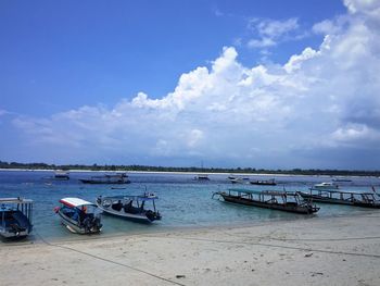 Boats moored on sea against sky