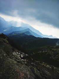 Scenic view of mountains against cloudy sky