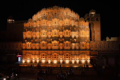 Group of people in illuminated building at night