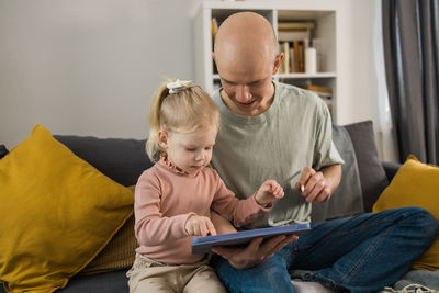 Family using digital tablet at home