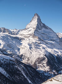 Scenic view of snowcapped mountains against clear sky