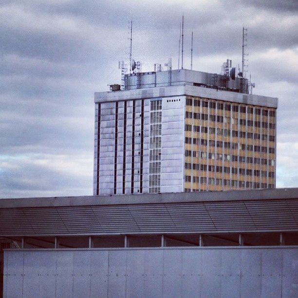 architecture, building exterior, built structure, sky, low angle view, cloud - sky, cloud, city, building, window, cloudy, modern, office building, day, tall - high, outdoors, no people, tower, development, exterior