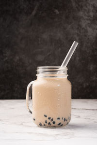 Close-up of drink in glass jar on table