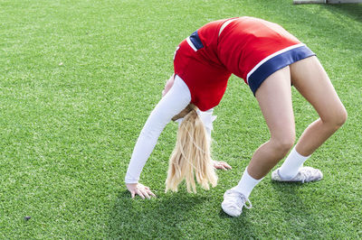 Rear view of person with umbrella on field