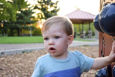 Close-up of boy against trees