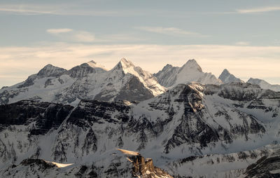 Scenic view of snowcapped mountains against sky during sunset