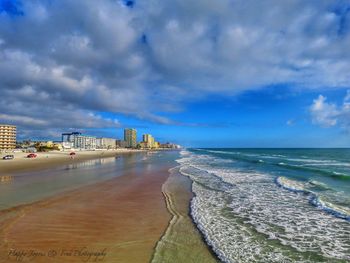 View of beach against cloudy sky