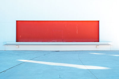 Red empty tiled floor against wall