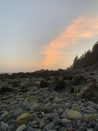 Surface level of rocks against sky during sunset