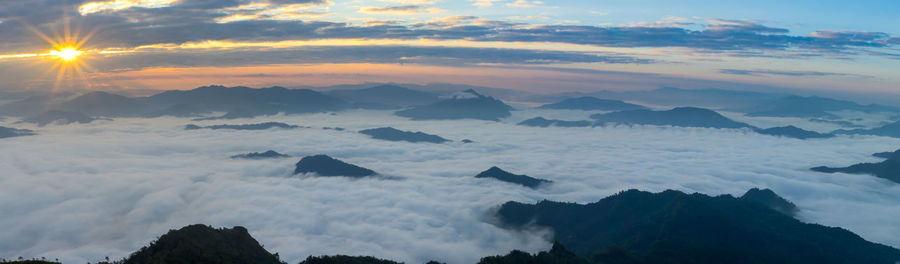 Scenic view of silhouette mountains against sky at sunset