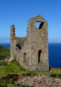 Old ruin building against clear blue sky