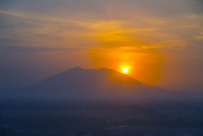 Silhouette mountains against sky during sunset