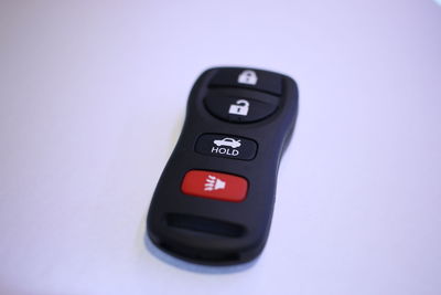 Close-up of car remote control over white background