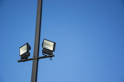 Low angle view of street light against clear blue sky