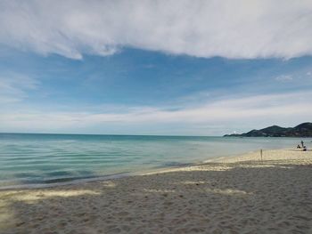 View of beach against cloudy sky