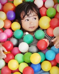 High angle view of cute girl in ball of pool